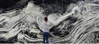 Female looking at large black and white mural