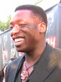Profile shot of a man on the red carpet in a black blazer